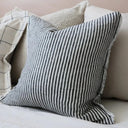 Charcoal striped linen cushion cover with a frayed edge