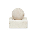 A square-shaped sculpture made of travertine limestone with a fibrous texture, displayed on a white square base.
