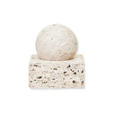 A square-shaped sculpture made of travertine limestone with a fibrous texture, displayed on a white square base.