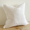 A white linen cushion cover with a zipper closure.