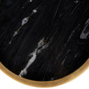 Small round side table with black marble top and aged gold metal frame. 