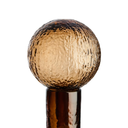 Sculptural brown glass bottle adding warmth and character to a sophisticated interior.
