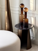 Decorative brown glass bottle with artisanal texture and unique sculptural form.