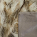 Close-up of a faux fur textile with mixed cream, tan, and brown tones, alongside a smooth taupe-gray fabric panel.